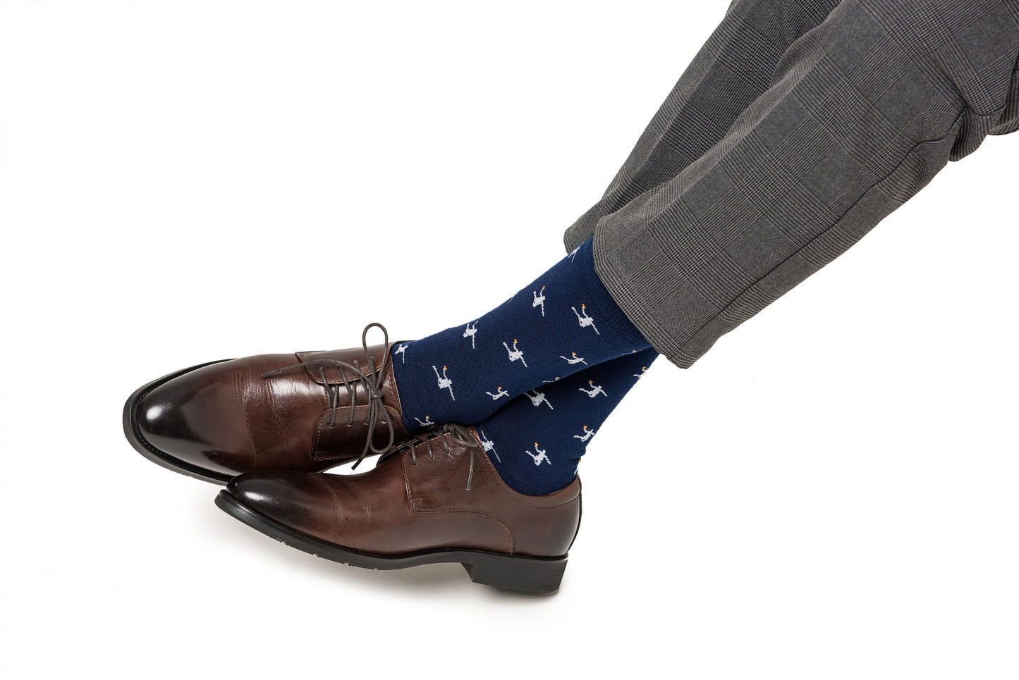 A man wearing a pair of brown shoes and Basketball Dunk Socks.