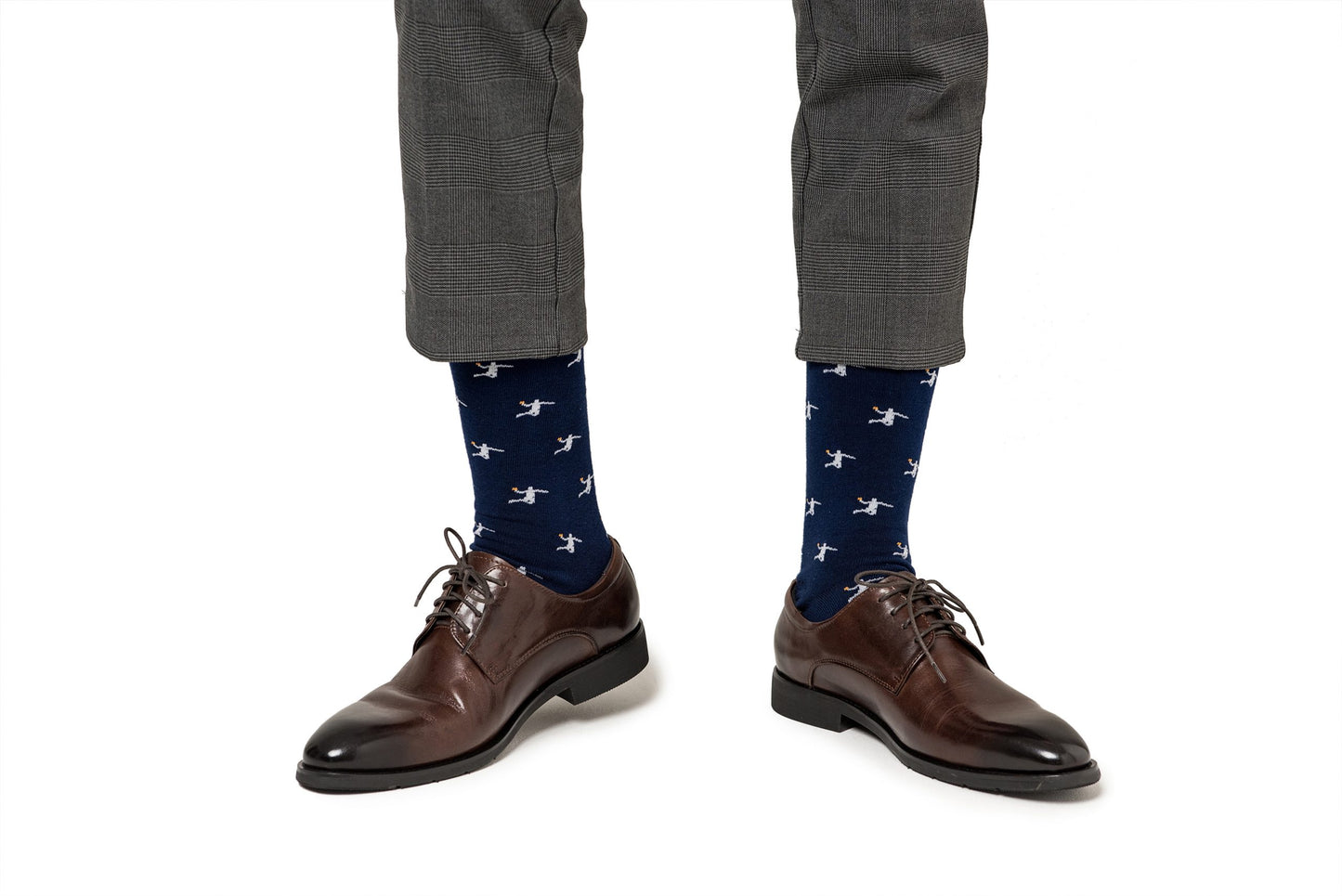 A pair of legs wearing brown shoes and Basketball Dunk Socks.