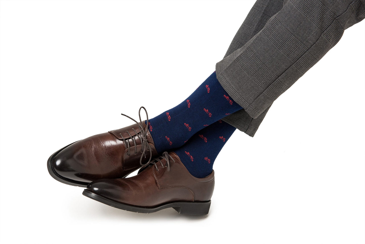 A man wearing a pair of brown shoes and Cyclist Bike Socks.