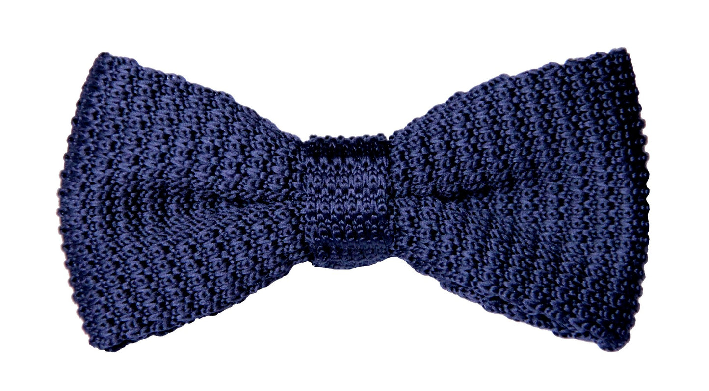 A black knit bow tie exudes a sense of relaxed sophistication against the crisp white background.