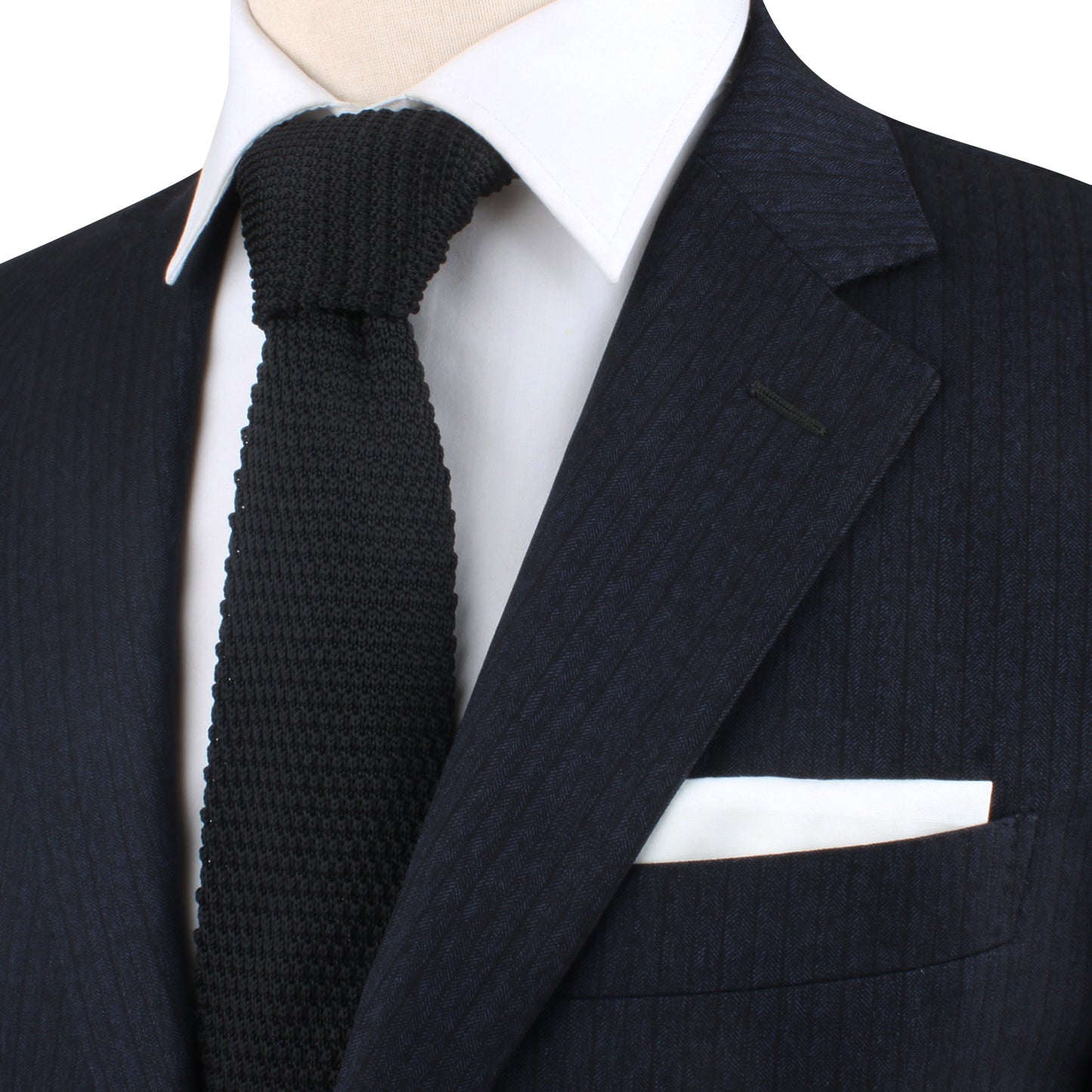 A mannequin exuding classic charm in a Black Knitted Skinny Tie and suit.