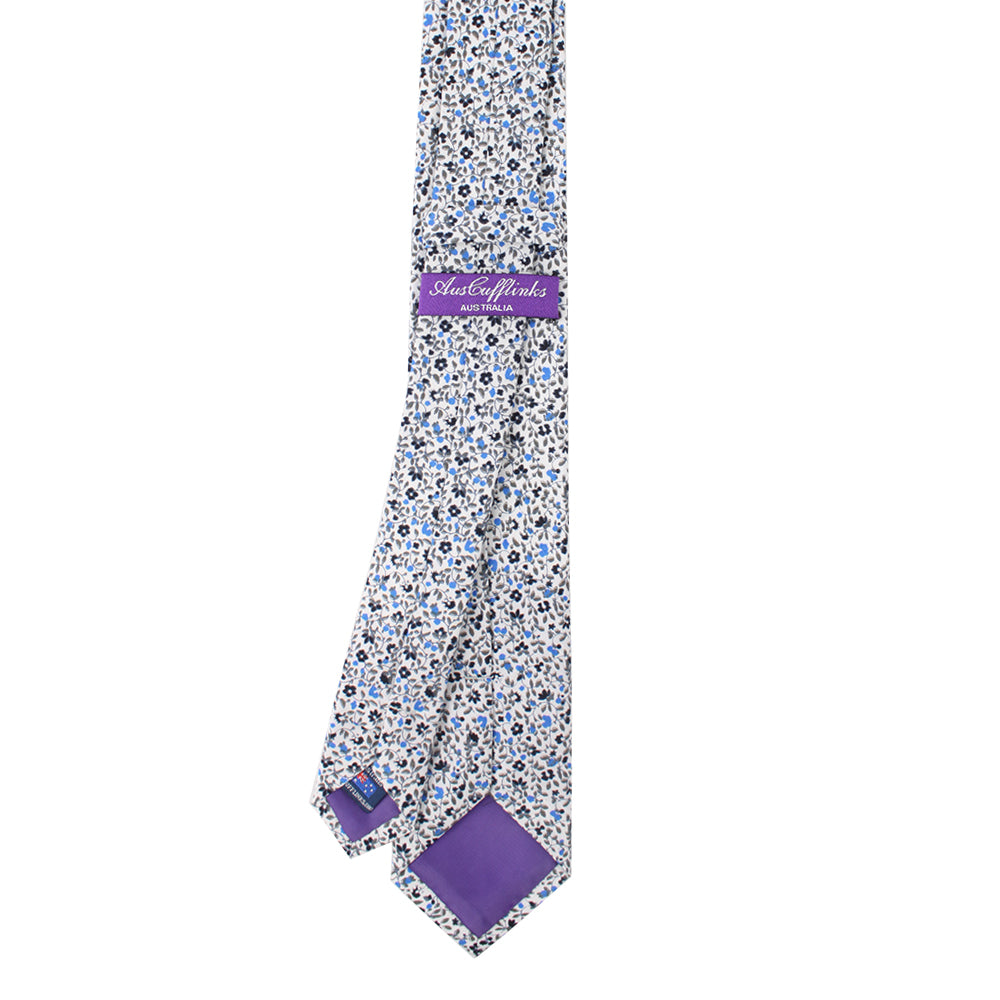 A tie with bold contrasts of black, light blue floral.