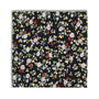 The Multi Floral Pocket Square features a black background with vibrant red, white, and yellow florals, green leaves, and a light green border, making it a stylish accessory to add flair to any outfit.