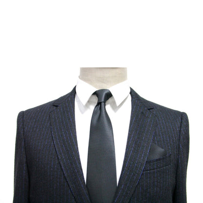 A formal mannequin in a suit and tie, accessorized with a Black Pocket Square.