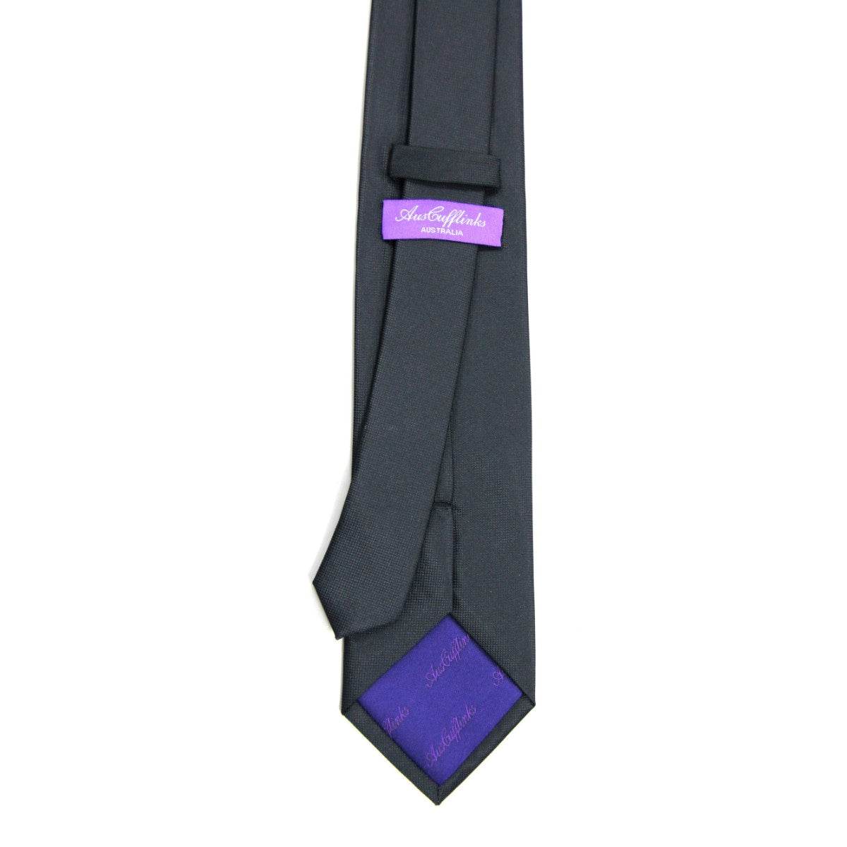 A neatly arranged Black Business Tie & Pocket Square Set with the brand label "Astor & Black" visible on a purple tag exudes impeccable elegance and formality.