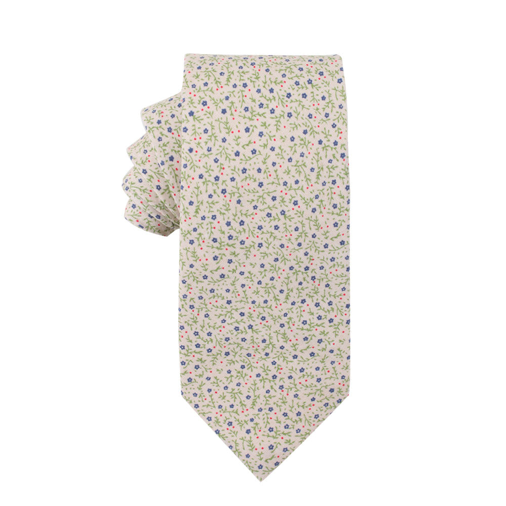 The Blue Forget-Me-Nots Floral Skinny Cotton Tie is a cream-colored necktie exuding professionalism, featuring a delicate floral pattern with elegant peach, green, blue, and pink accents.