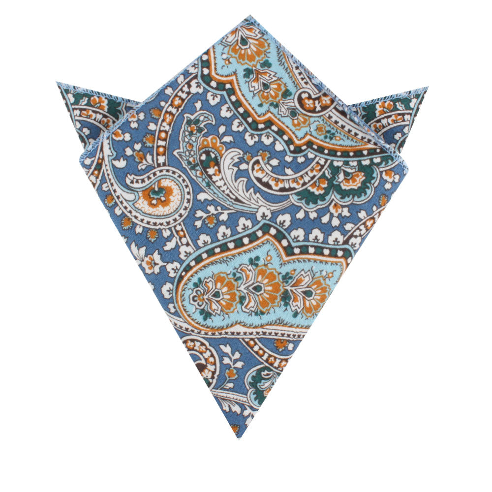 A pocket square, elegantly folded to highlight the blue, orange, and green paisley design, complements any outfit with style.