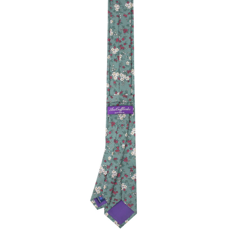 Blue, white, and pink floral necktie adorned with a delicate bouquet of pastel flowers, featuring a distinctive purple label.