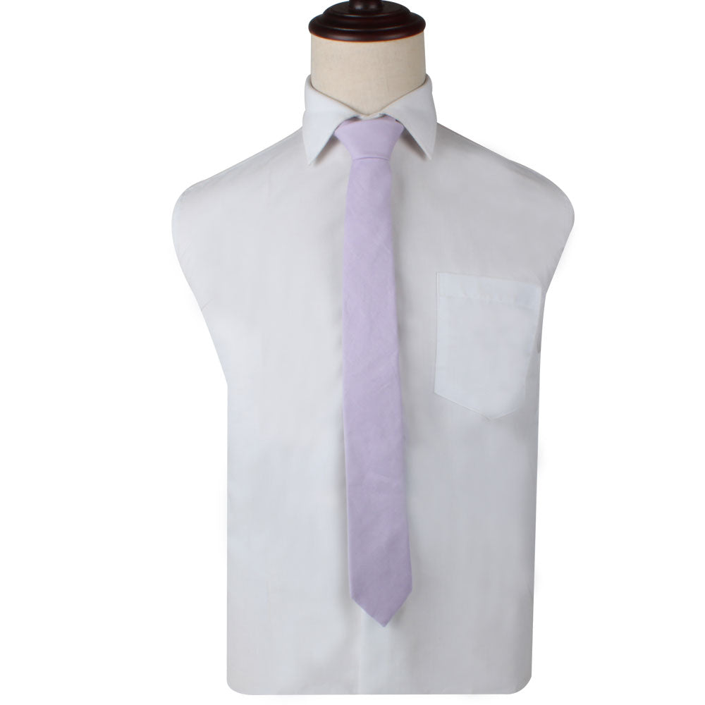 On a mannequin torso, a luxury white dress shirt features a front pocket, complemented by the Blush Purple Skinny Necktie and Pocket Square Set.