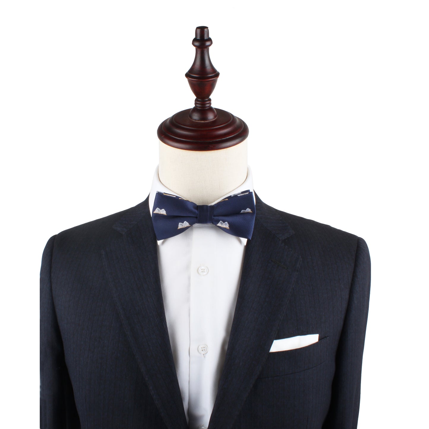 A mannequin dressed in a dark suit jacket, white dress shirt, and the stylish Book Bow Tie stands on display, ready to script your style story.