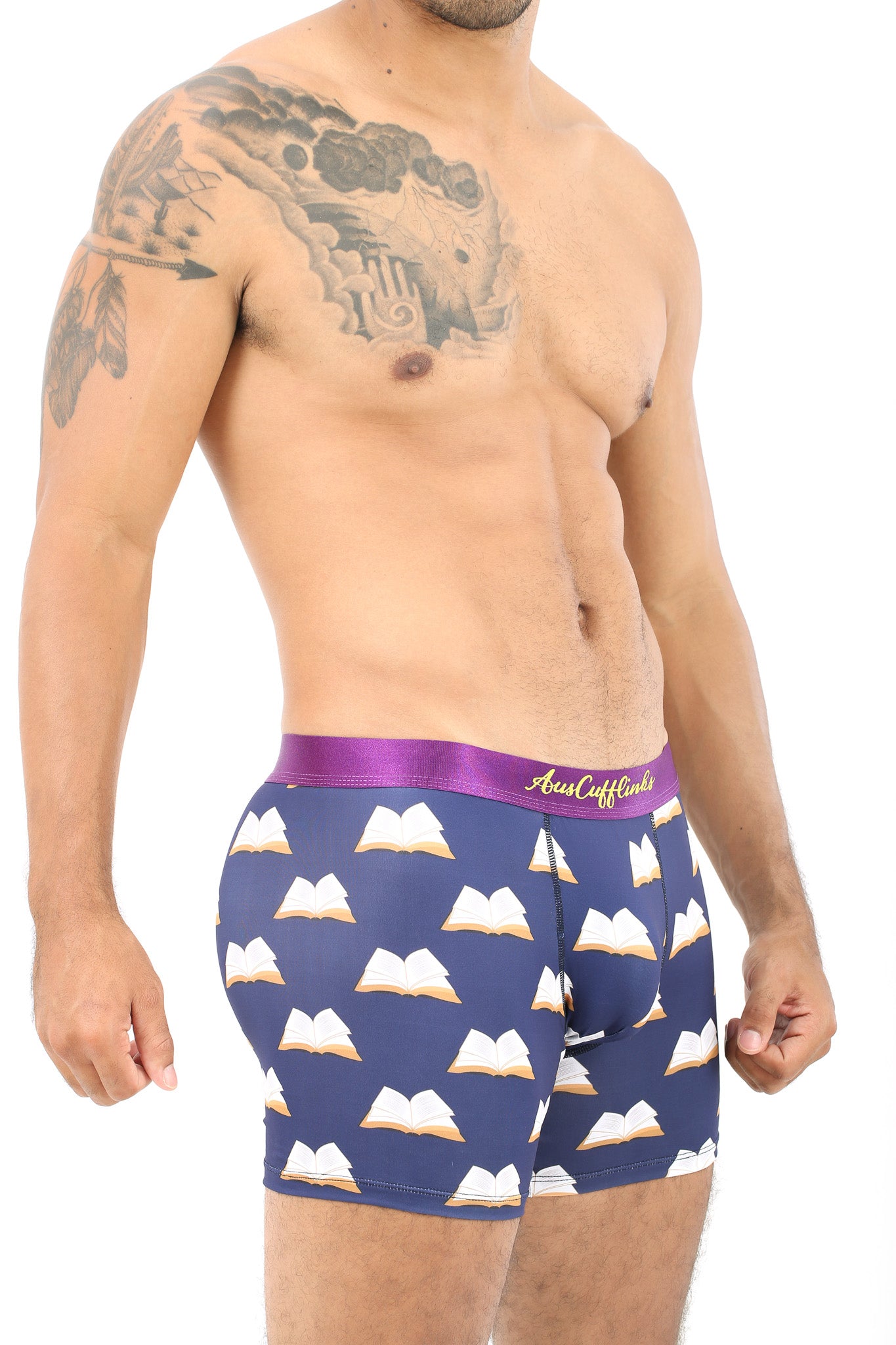 A shirtless man models Book Underwear – Fun Gift for Book Lovers, featuring a navy blue open book pattern and a purple waistband, standing against a white background.
