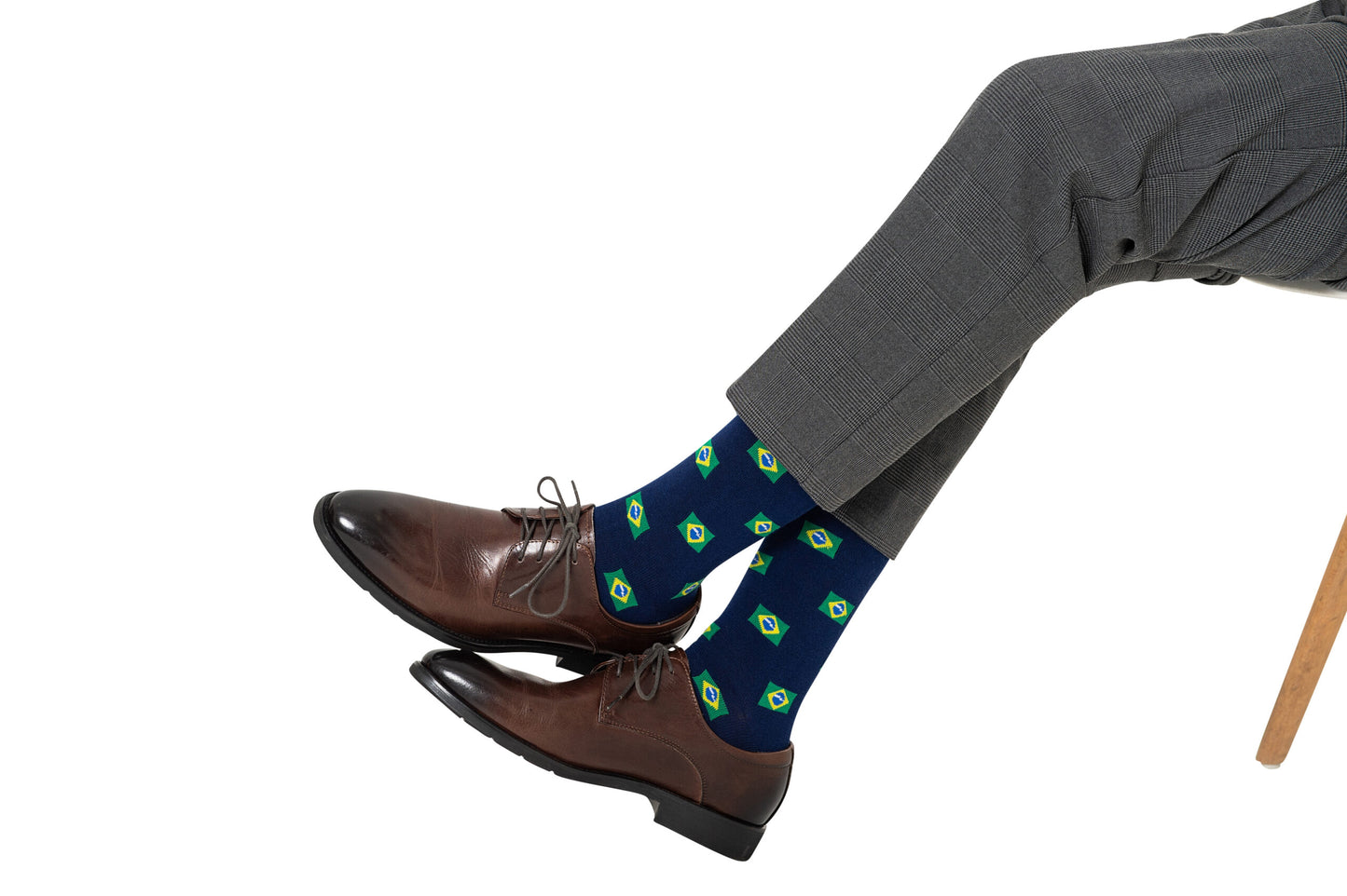 A pair of Brazil Flag Socks worn on legs.