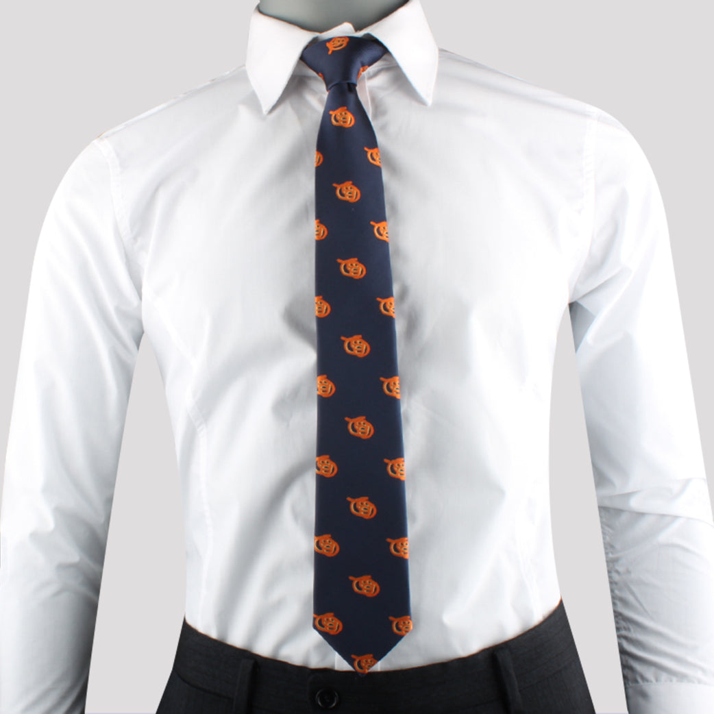 A person wearing a white dress shirt, paired with dark trousers and the Bread Skinny Tie featuring an orange emblem pattern, exudes charisma effortlessly.
