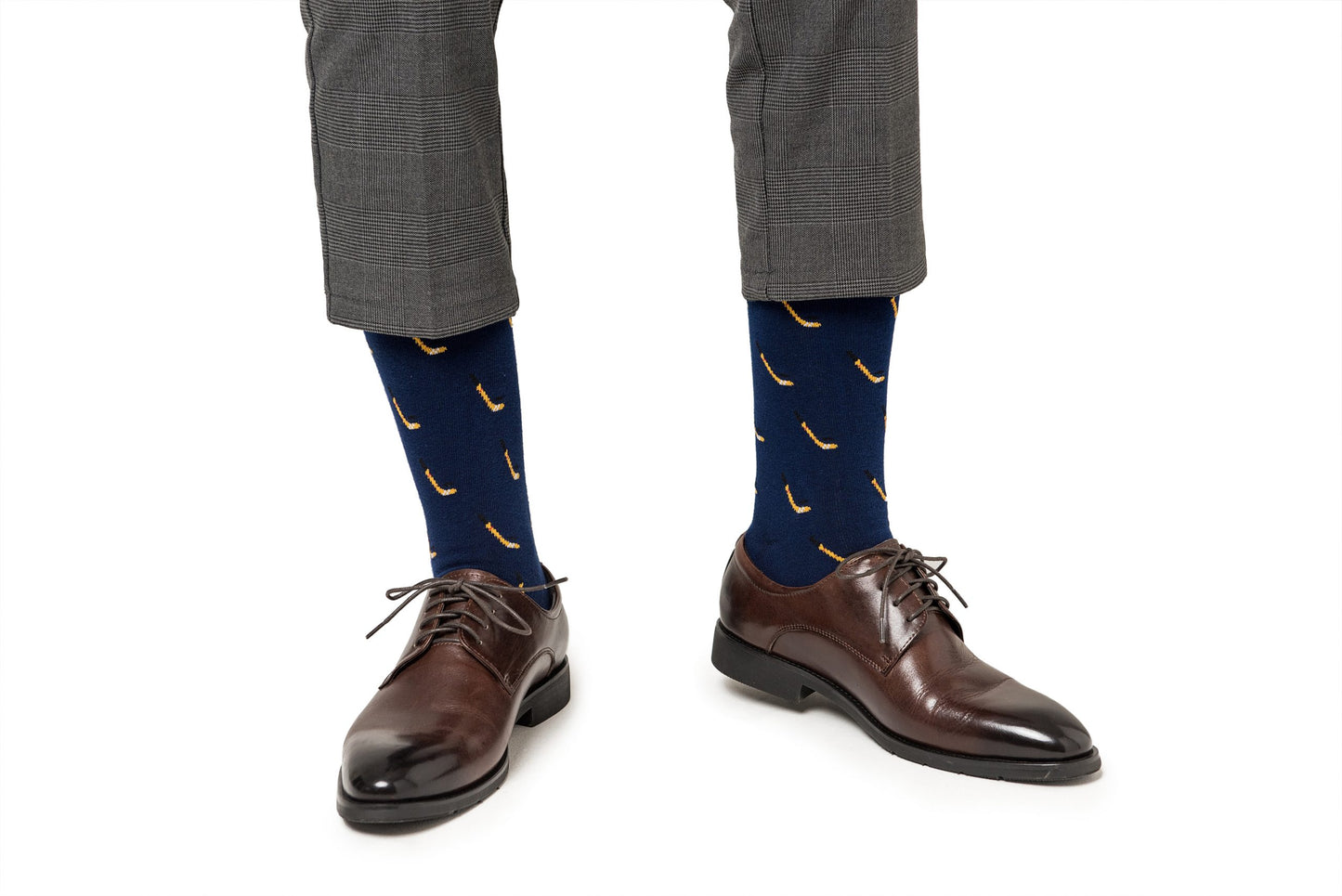 A man wearing a pair of brown shoes and Ice Hockey socks.