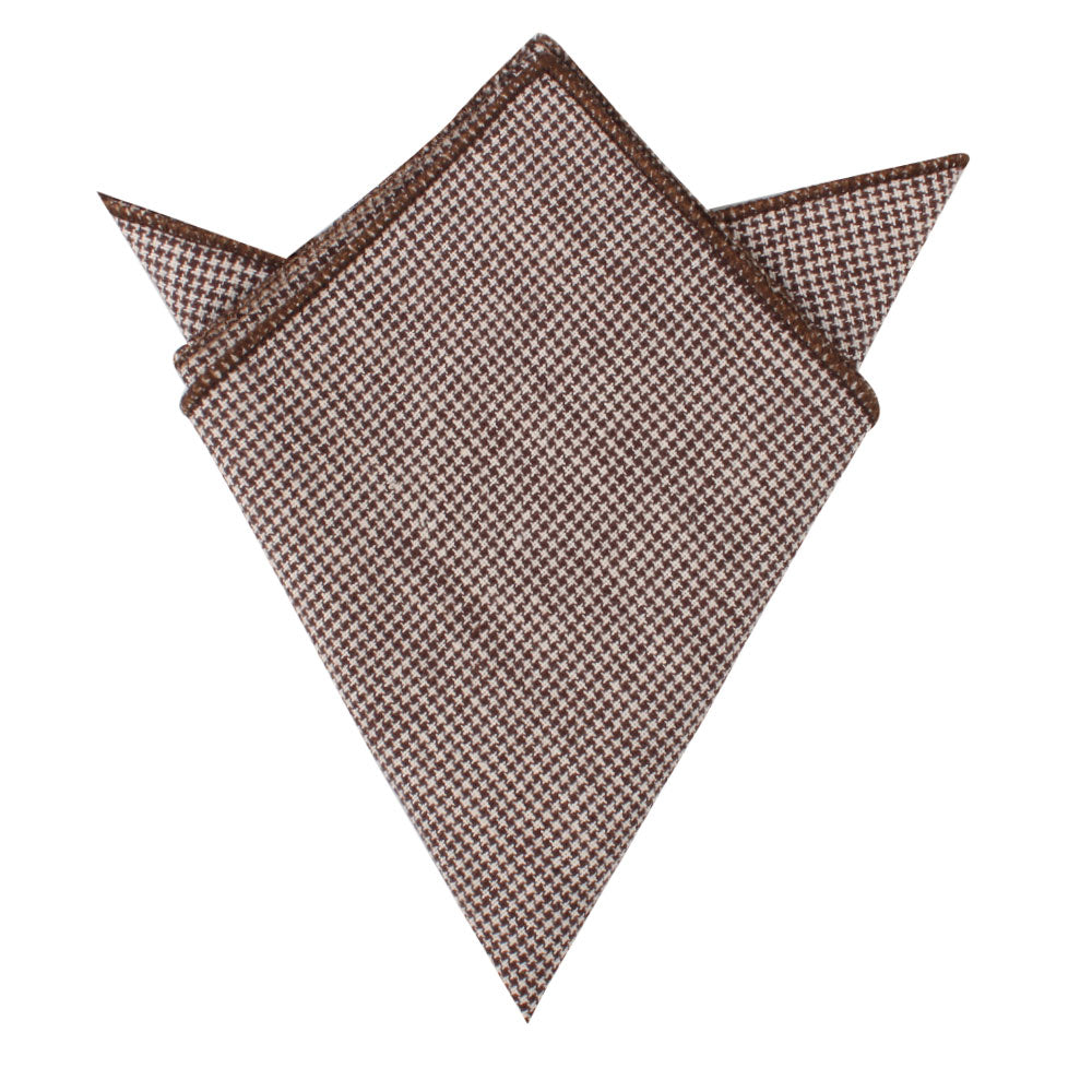 The Brown Mini Houndstooth Cotton Bow Tie & Pocket Square Set features a pocket square with pointed edges, showcasing timeless elegance.