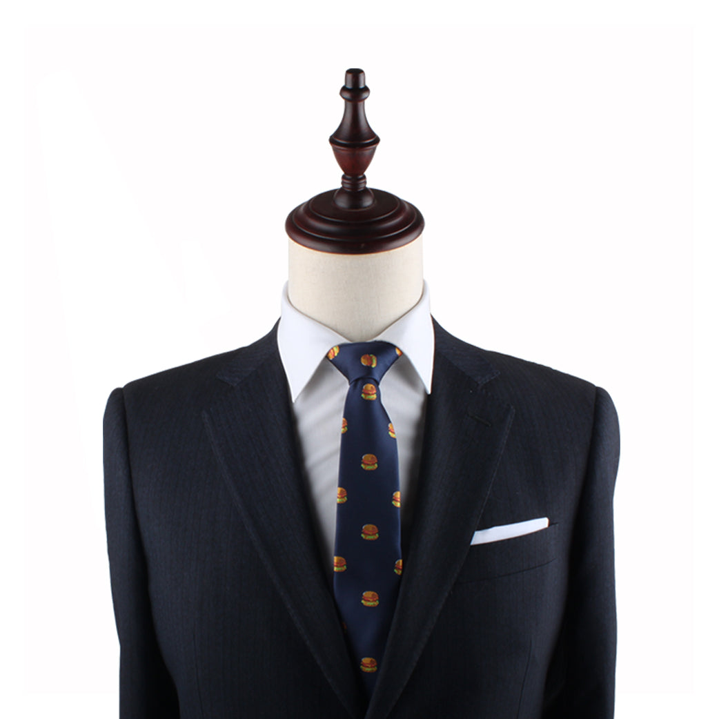 A mannequin dressed in a dark suit and a crisp white shirt, featuring the Burger Slim Tie, makes a statement of universally adored quirky style.