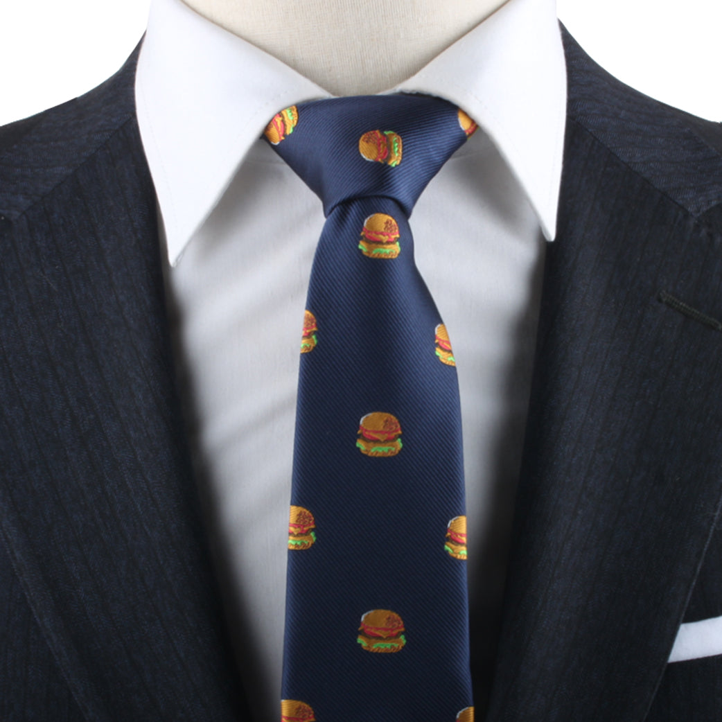 Close-up of a man dressed in a dark suit and white shirt, showcasing a universally adored style with the Burger Themed Tie.