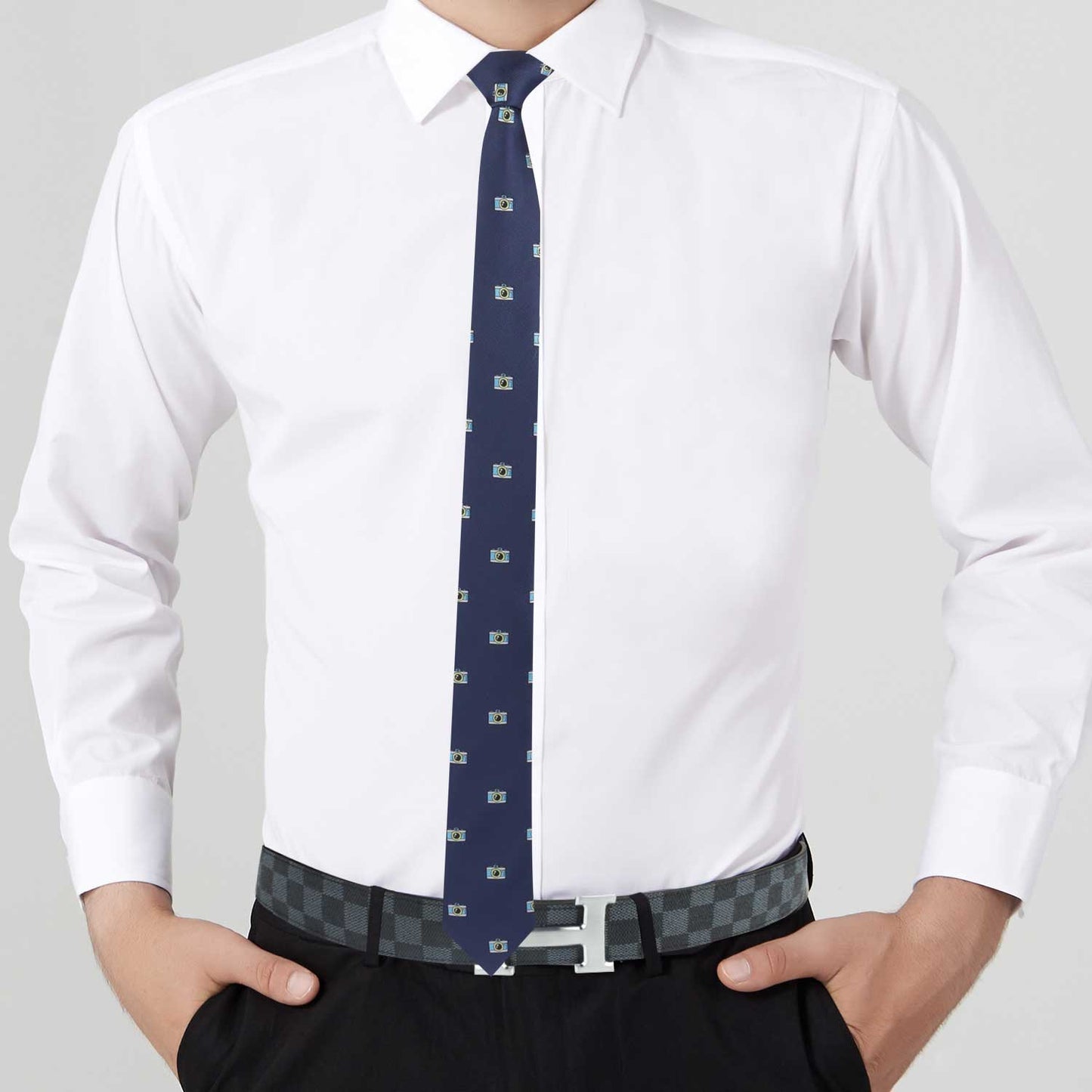A man with Camera Pattern Necktie wearing a blue tie and white shirt.