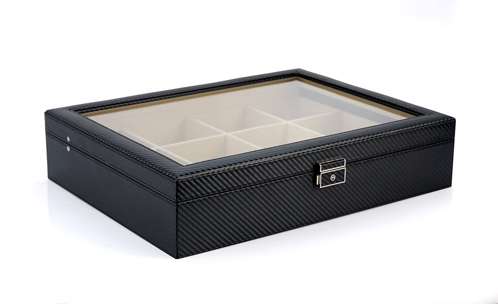 The Carbon Fibre Tie Box features a sleek black design with a glass top, lockable latch, and multiple compartments—perfect for storing ties or as a stylish complement to any premium tie case.