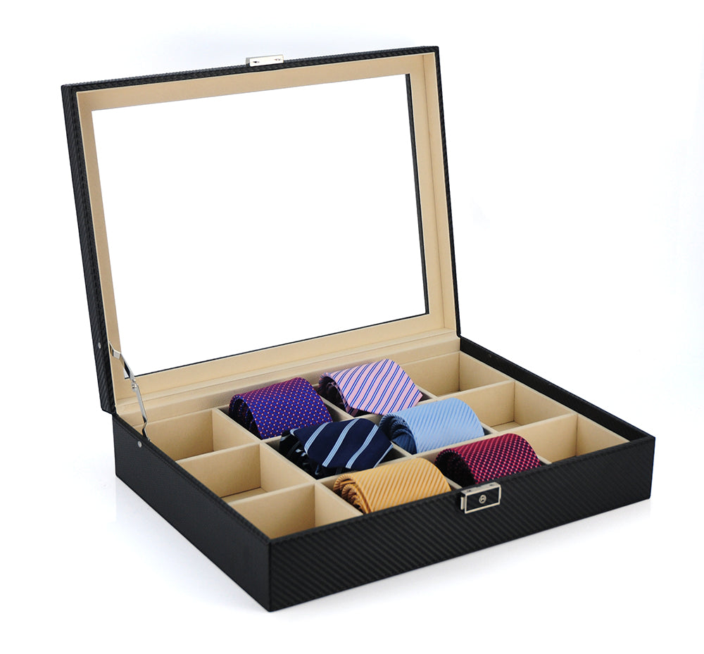 The Carbon Fibre Tie Box features a glass lid and nine compartments for neatly rolled neckties in assorted colors and patterns—a stylish, organized storage solution.