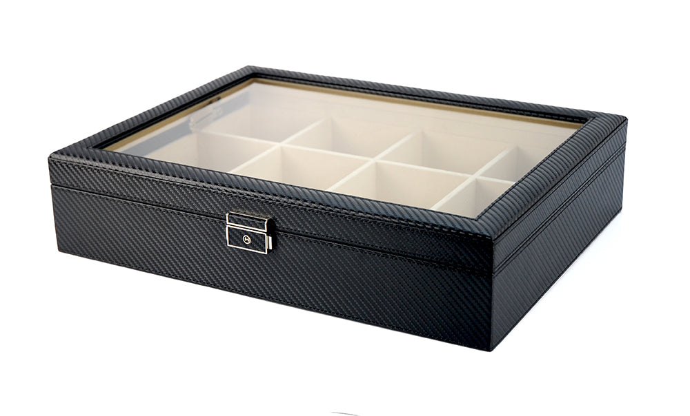 The Carbon Fibre Tie Box features a black carbon-fiber texture, glass lid, lock, and multiple compartments—making it a premium and stylish storage solution for your ties and accessories.