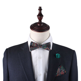 A mannequin wearing a suit and Carpe diem Paisley Bow Tie, showcasing vivid paisley colours.