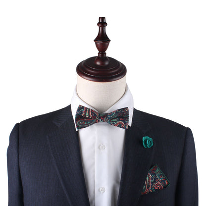 A mannequin wearing a vibrant suit and bow tie with Carpe diem Paisley Cotton Bow Tie & Pocket Square Set paisley pattern.