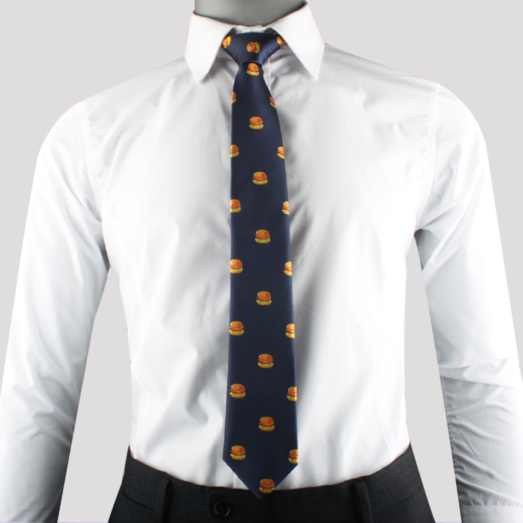 A mannequin dressed in a white shirt and black pants makes a bold statement with its Cheeseburger Tie adorned with a pattern of universally adored small cheeseburgers.