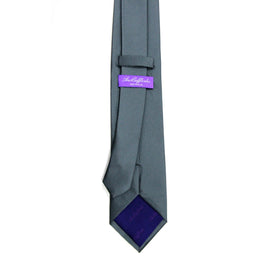 A Classic Grey Skinny Tie with a purple label on it.
