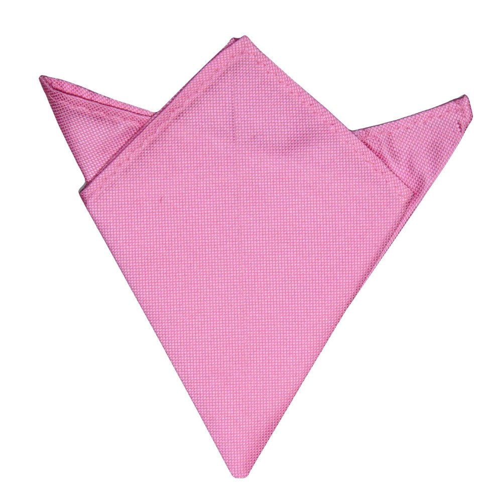 A timeless pink accessory, the Pink Pocket Square is elegantly folded in a simple, triangular design.