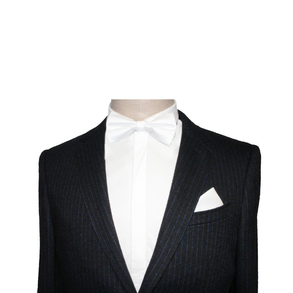 A mannequin displays a stylish black pinstripe suit paired with a white shirt, Classic White Bow Tie, and white pocket square against a simple backdrop—ideal for weddings or elegant black-tie occasions.