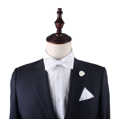 A mannequin in a suit ensemble with a white bow tie and Classic White Cotton Pocket Square, showcasing timeless white elegance.