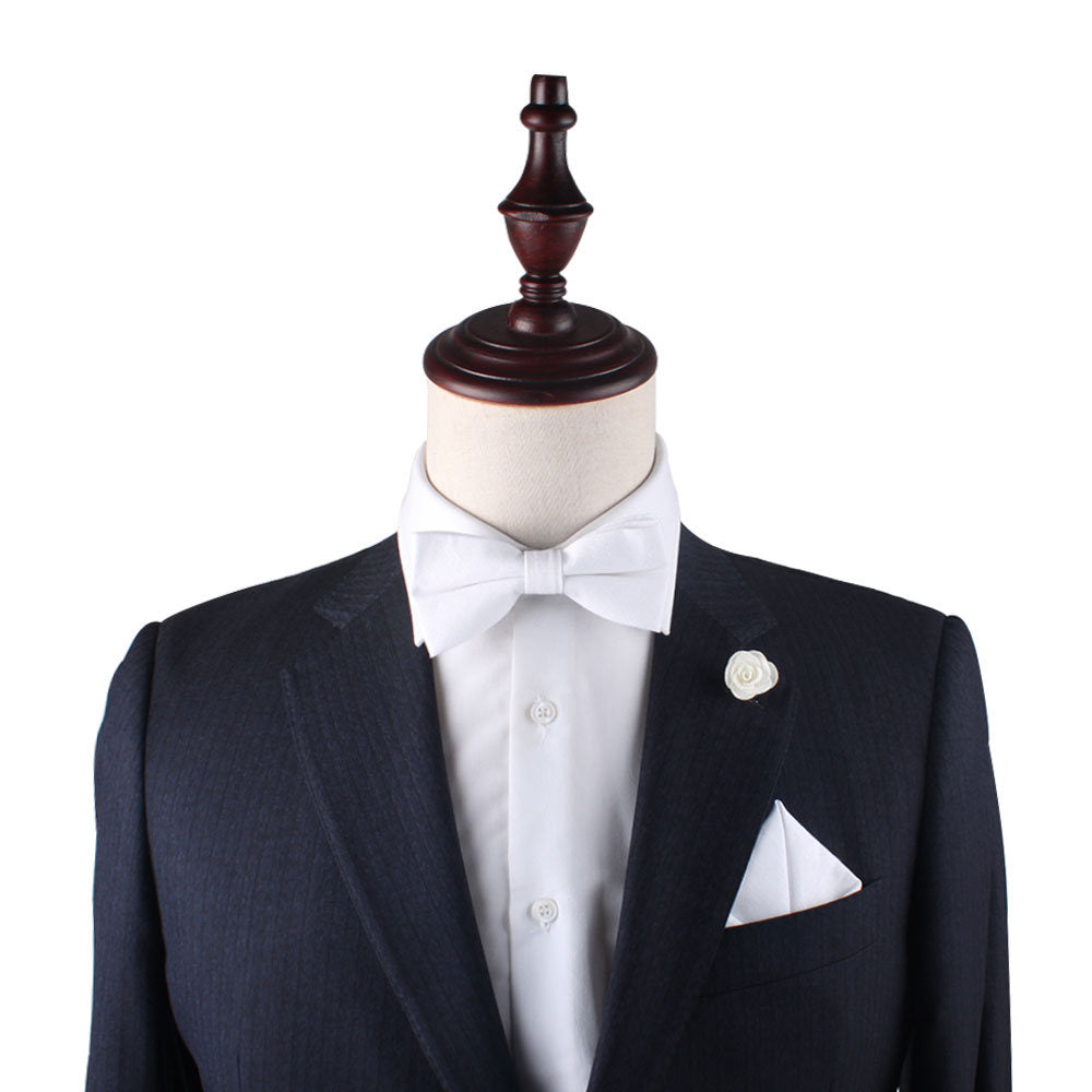 A mannequin with a Classic White Cotton Bow Tie & Pocket Square Set exudes elegance.