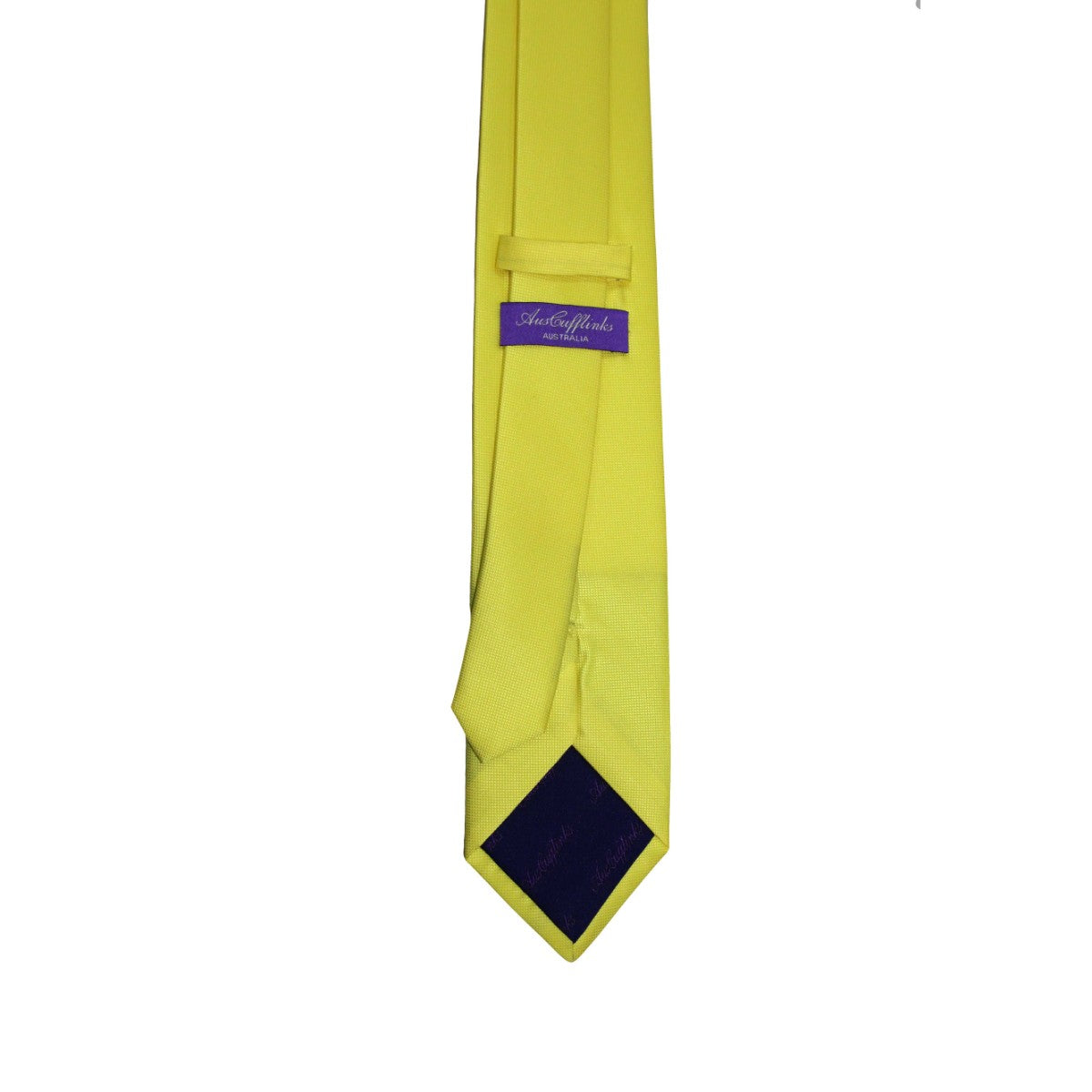 A Classic Yellow Skinny Tie is perfect to brighten up any outfit, featuring a bold yellow color with a purple label near the top.