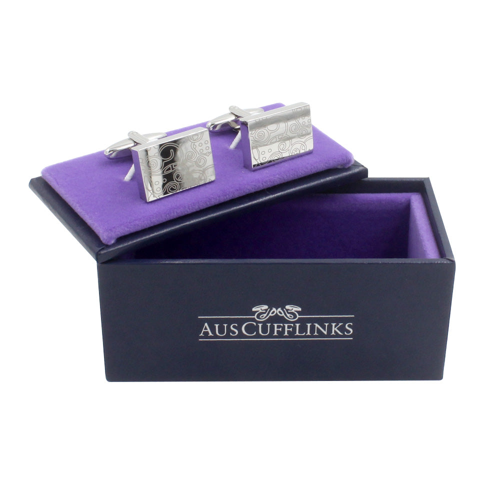 Paisley Cufflinks – Sleek & Modern Style for Men: Silver rectangular cufflinks with an engraved pattern offer timeless elegance, presented in a purple-lined box marked "AUSCUFFLINKS"—an ideal gift for him.