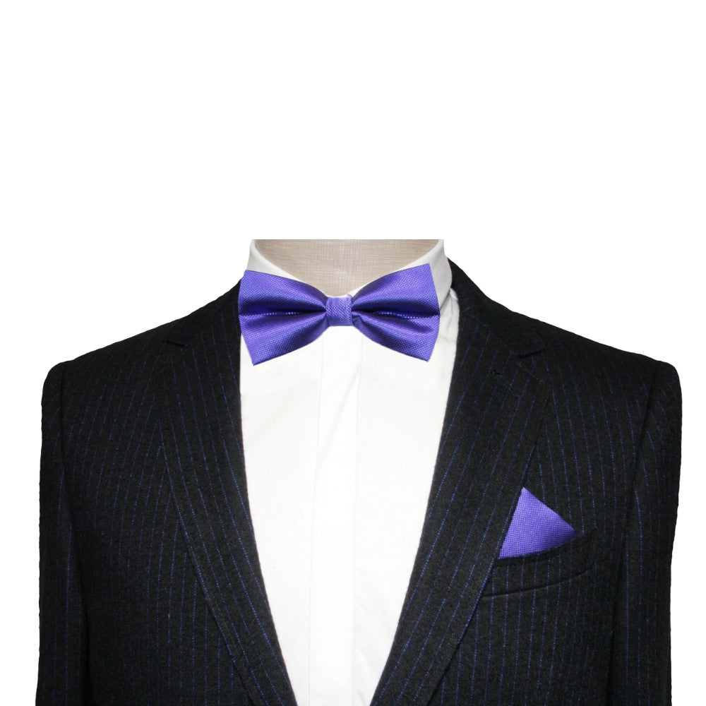 A mannequin in a dark pinstripe suit with a white shirt is stylishly enhanced by the Classic Purple Bow Tie and matching pocket square—ideal for formal events.