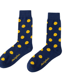 A pair of Cookie Socks with yellow dots on them.