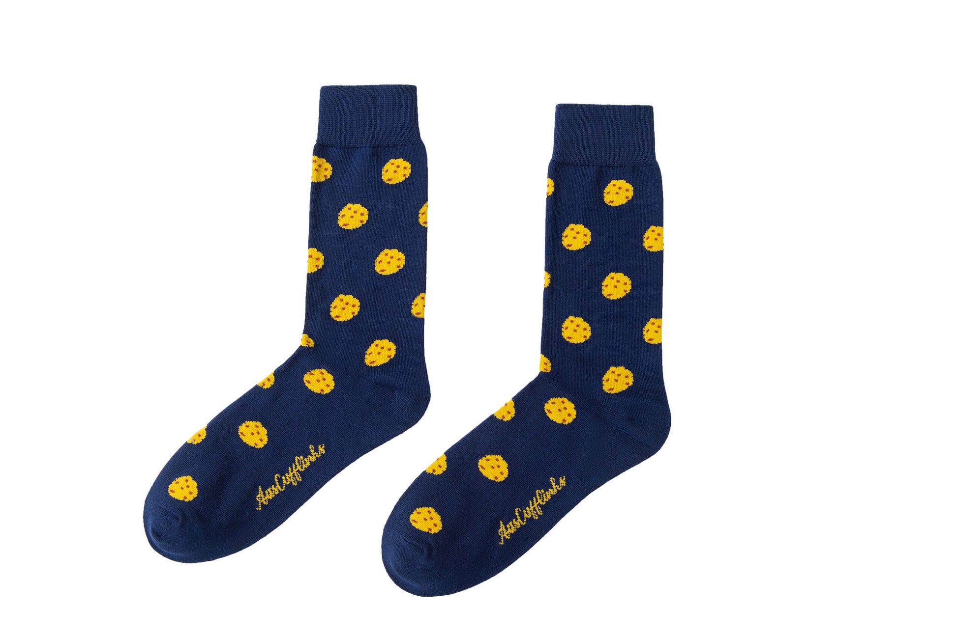 A pair of Cookie Socks with yellow dots on them.