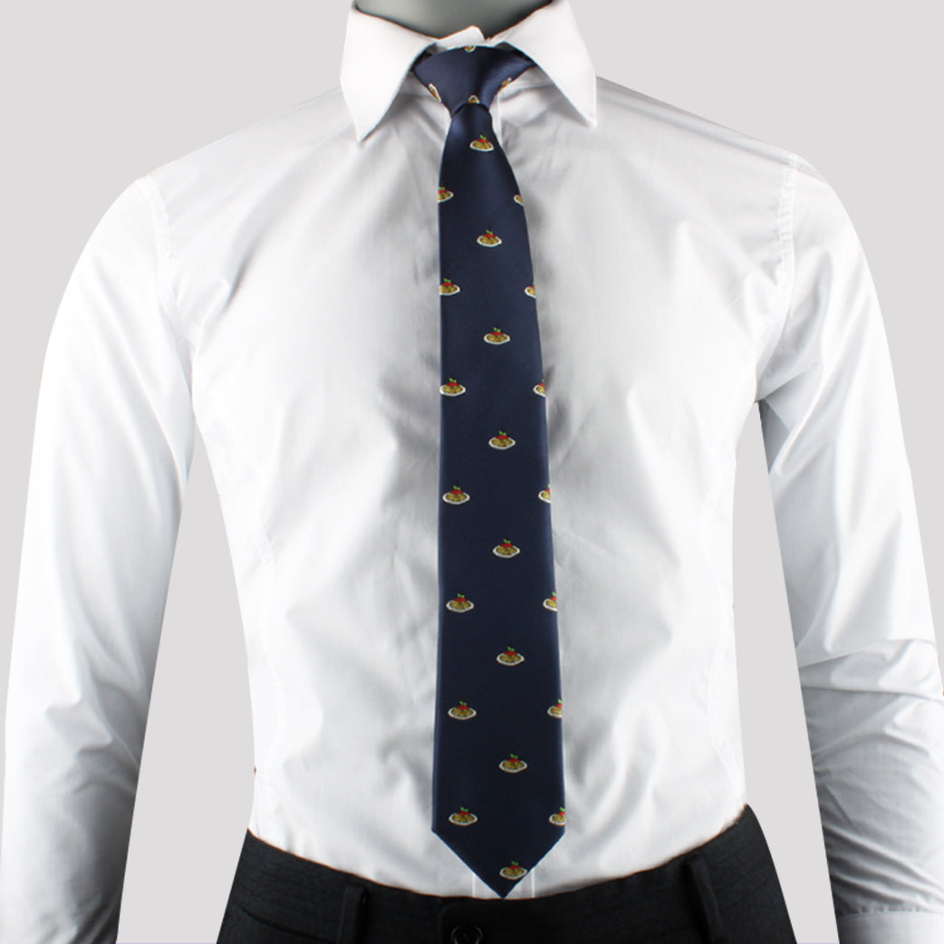 A person wearing a white dress shirt and the Cooking Enthusiast Tie, featuring a small repeating pattern in navy blue that exudes Italian flair and modern style.
