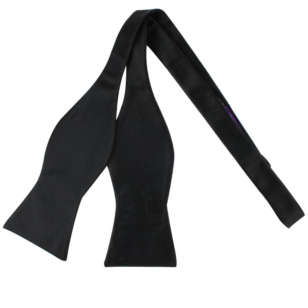 A classy Black Cotton Self Tie Bow Tie on a white background.