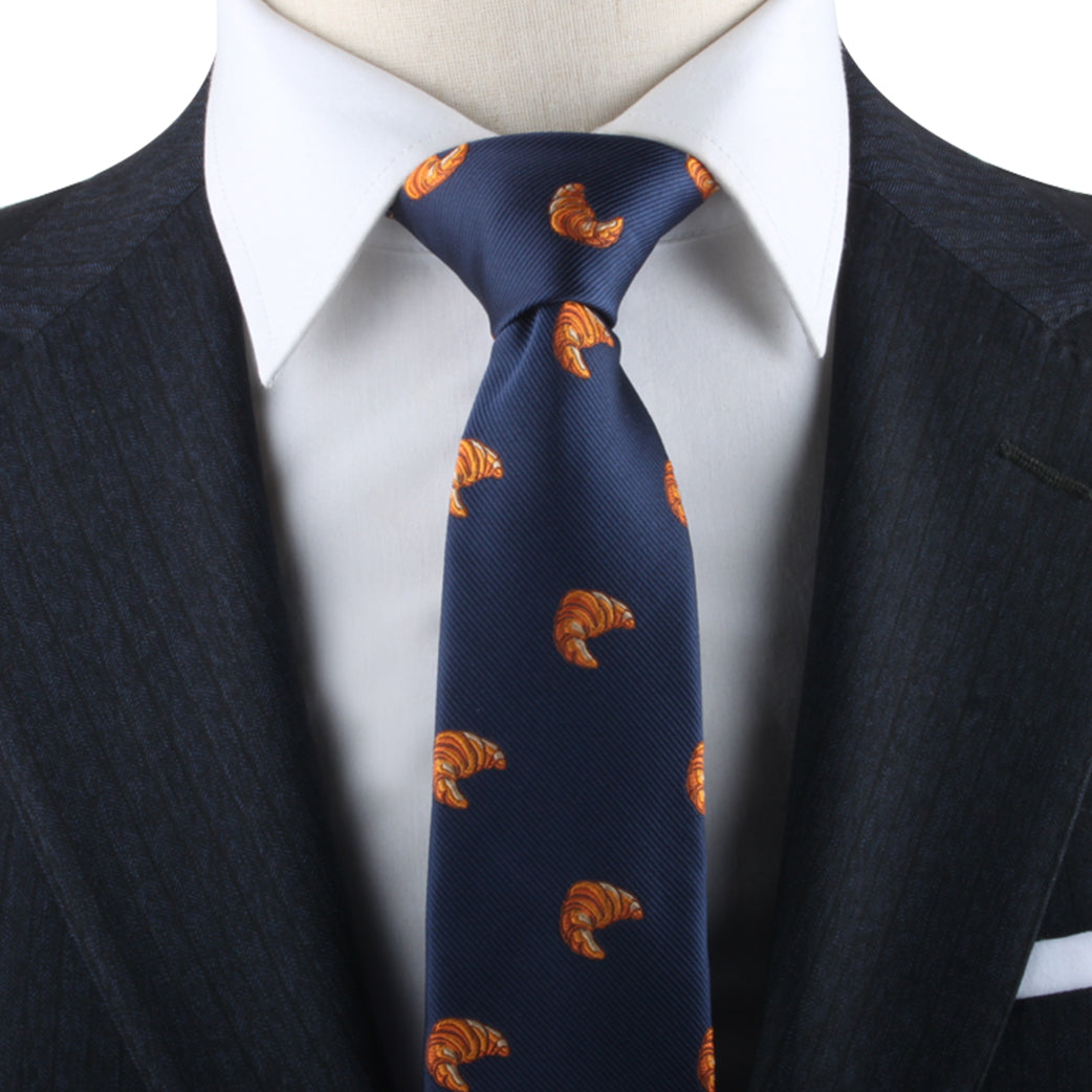 A mannequin in a stylish suit with a Croissant Necktie on it.