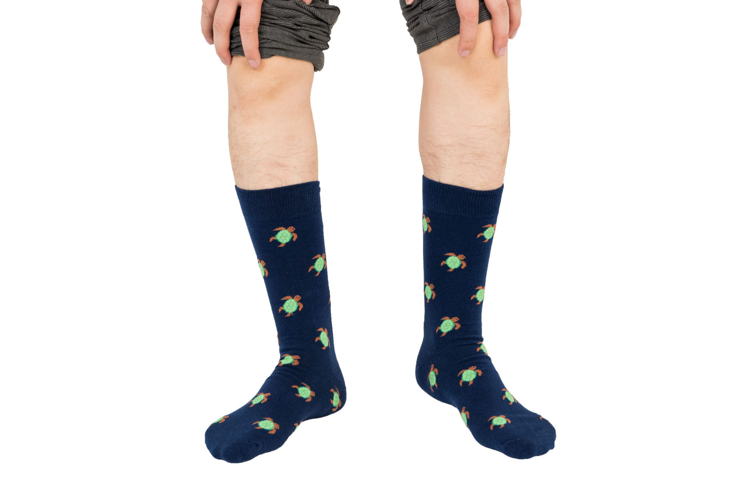 A boy wearing Green Turtle Socks.