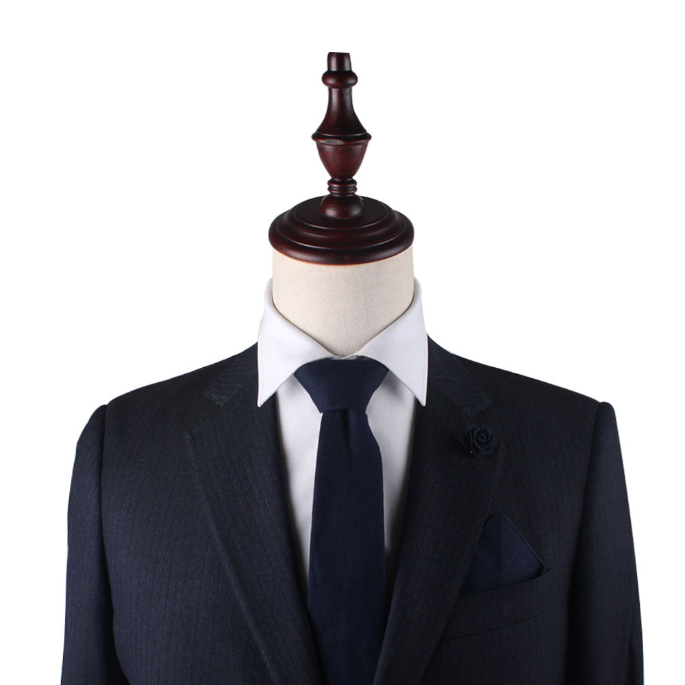 A mannequin wearing a Dark Forest Navy Pocket Square with versatile charm.