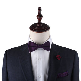 A man in a suit with a Dark Purple Bow Tie.