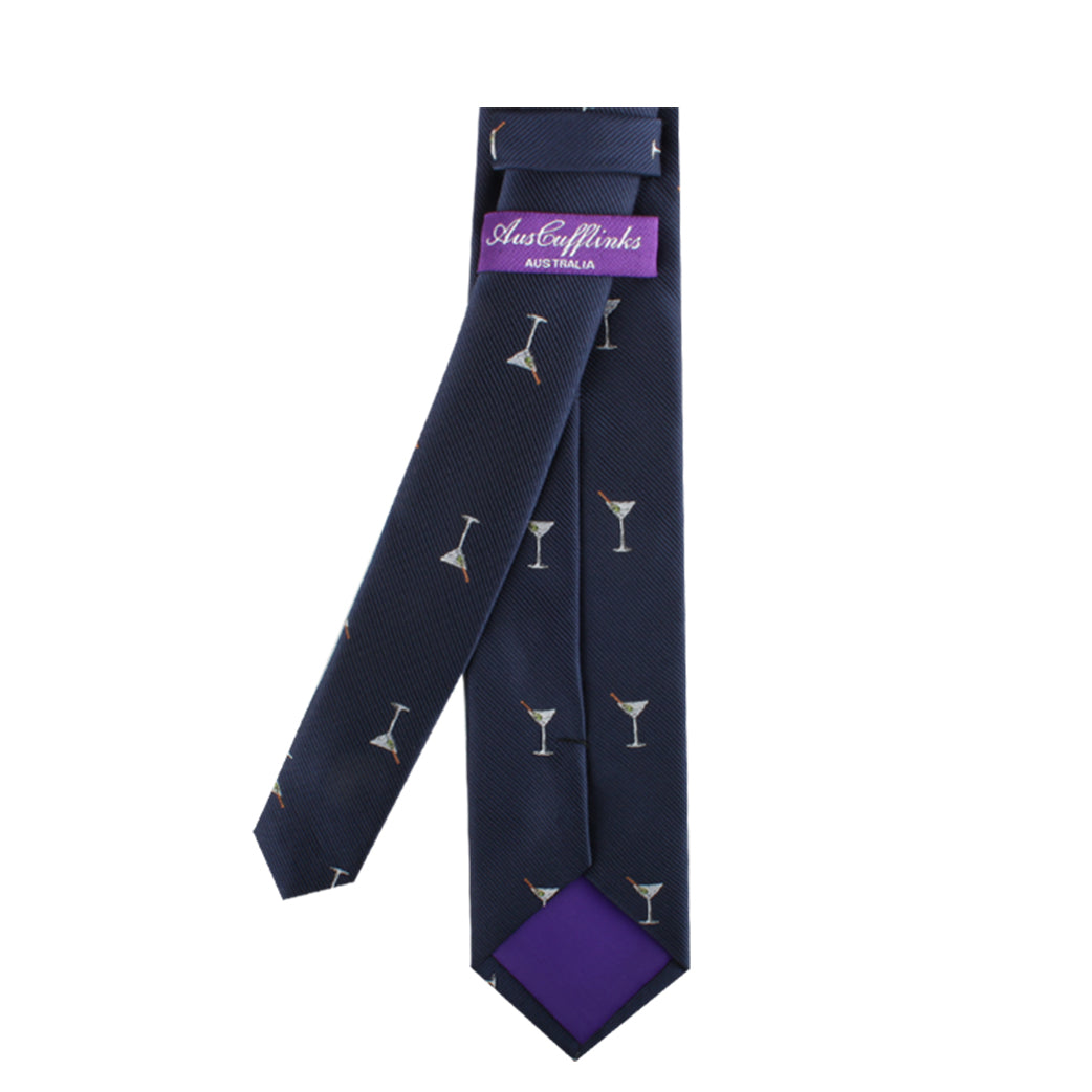 The Drink Lover Tie is a dark blue necktie adorned with a pattern of martini glasses, exuding classic charm and contemporary style. It features a purple label on the back that reads "Auster & Links Australia.