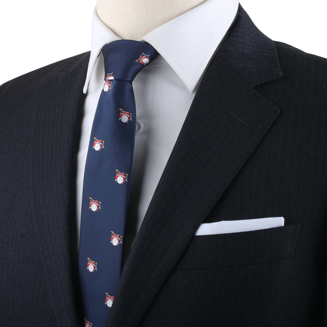 A stylish mannequin wearing a Drum Pattern Tie and blue suit.