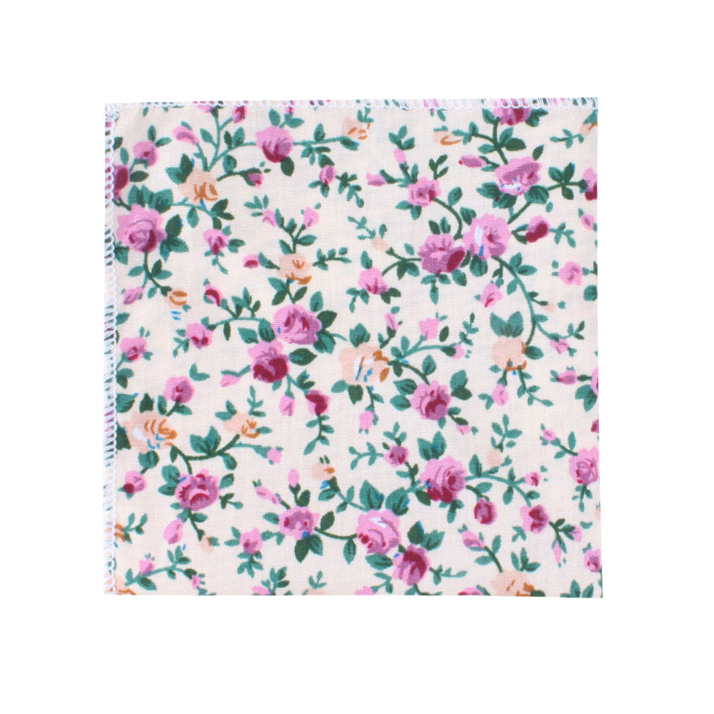 The Cream Floral Pocket Square features a delightful blend of pink and purple flowers with lush green leaves on a light background, making it a perfect accessory for weddings or formal events.