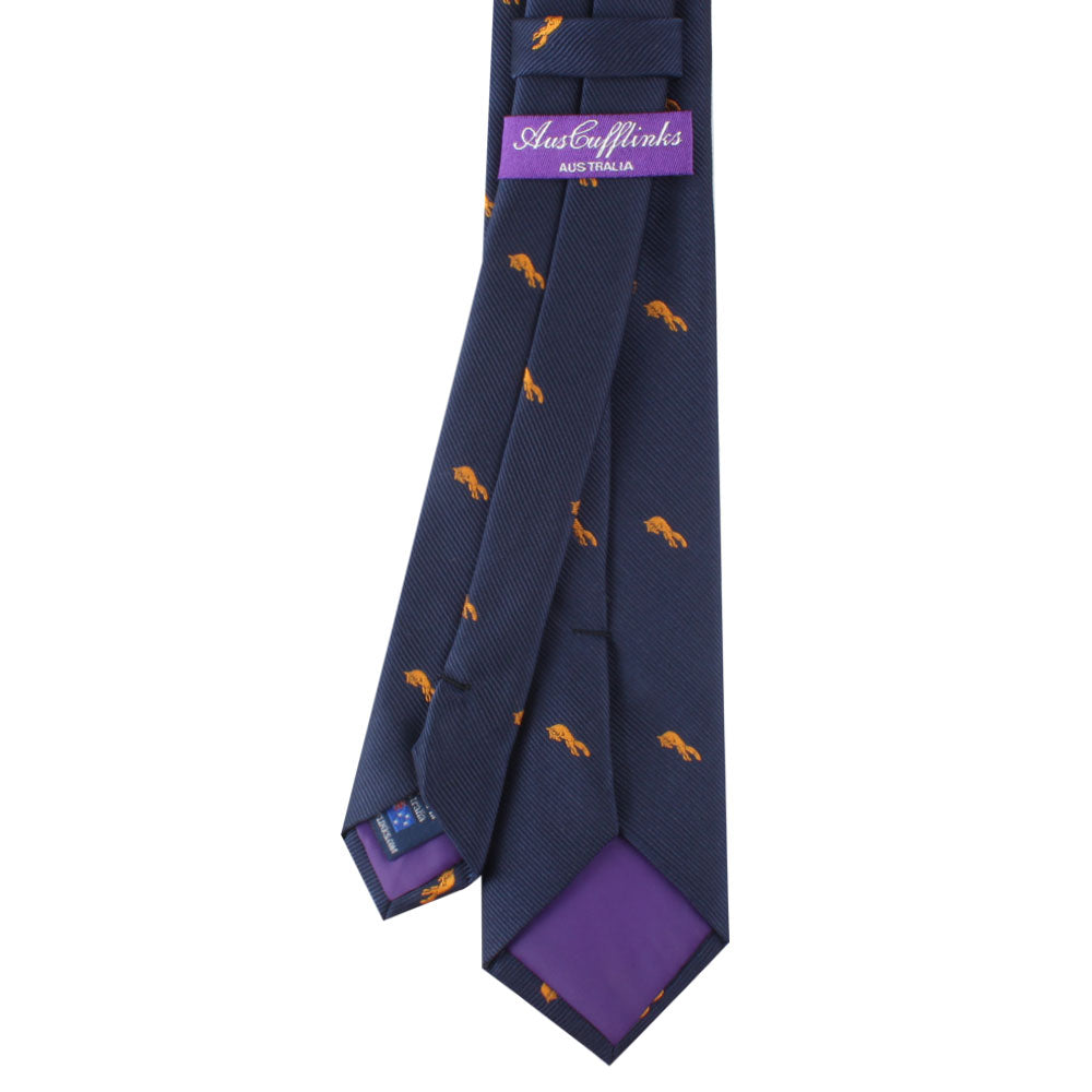 The Fox Patterned Tie showcases small orange fox designs on a navy blue background, featuring a purple inner lining and a label that reads "AustCufflinks Australia.