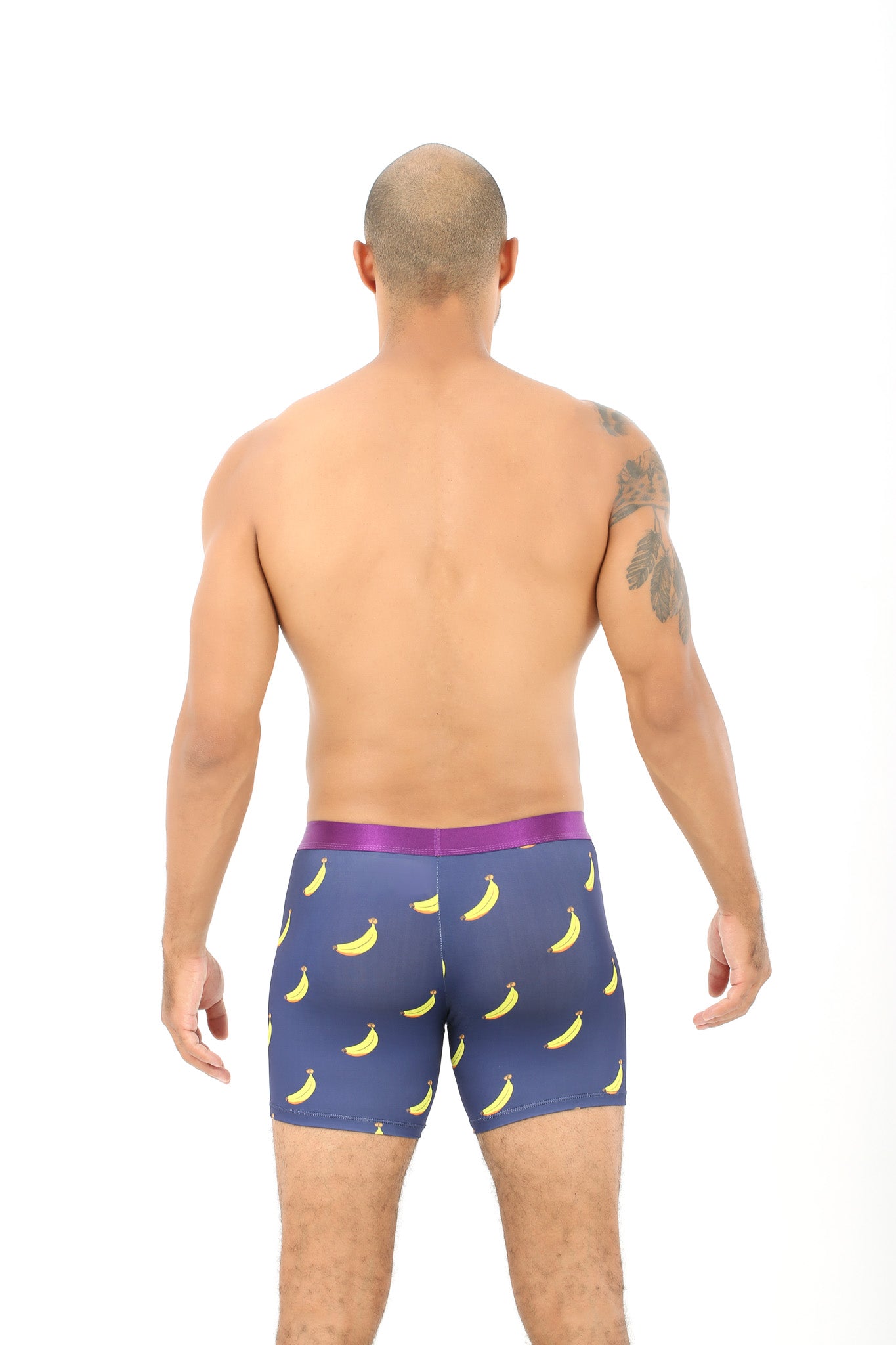 A man stands facing away, confidently wearing Banana Underwear featuring a perfectly whimsical banana pattern.