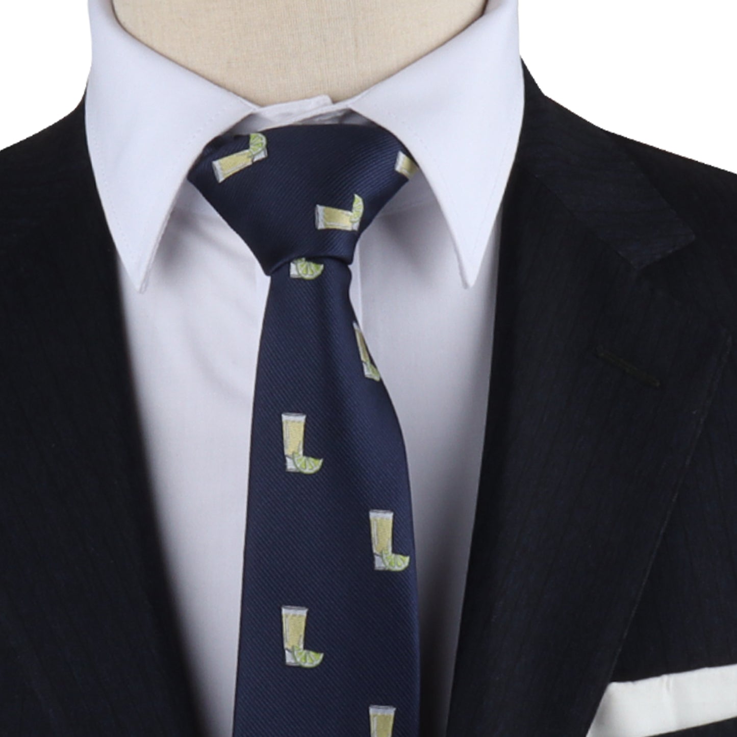 A person wearing a dark suit, white dress shirt, and the Tequila Skinny Tie exudes a zest-filled, dapper design with its playful pictures of green drinks in yellow cups.